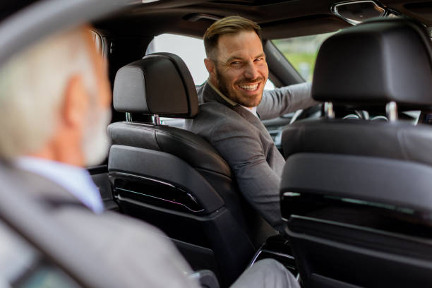 istock Smiling passenger engaging in friendly conversation with driver inside a modern car 2171001625