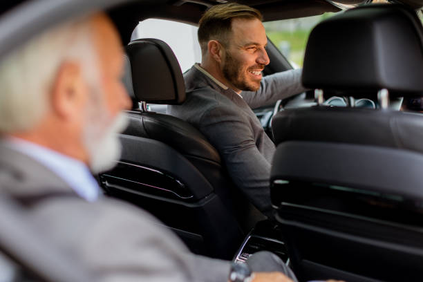 istock Smiling passenger engaging in friendly conversation with driver inside a modern car 2171001628
