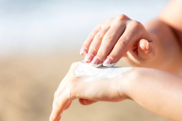 istock Woman hand apply sunscreen on the beach 2171002148