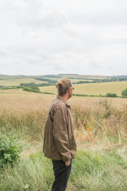 istock Young man explores rural landscape 2171003378