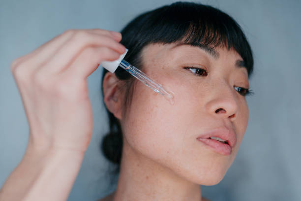istock Woman applying face serum 2171003783