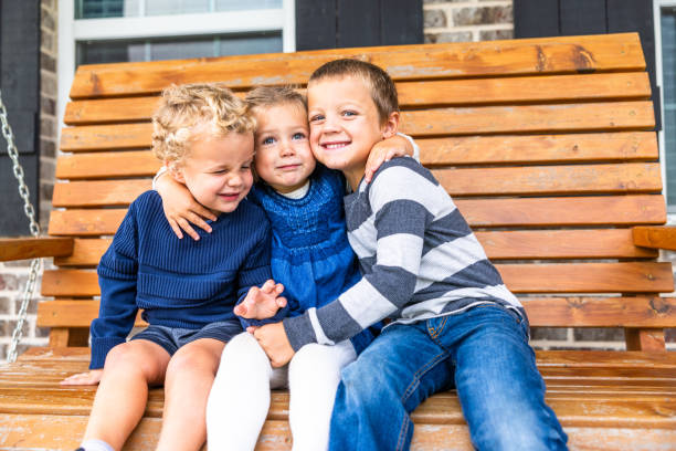 istock Siblings playing on porch swing 2171004542