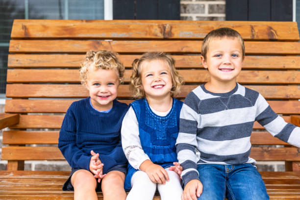 istock Siblings playing on porch swing 2171005046