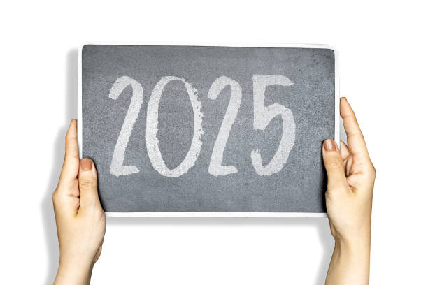 istock closeup hands holding a black chalkboard with 2025 happy new year 2171005174