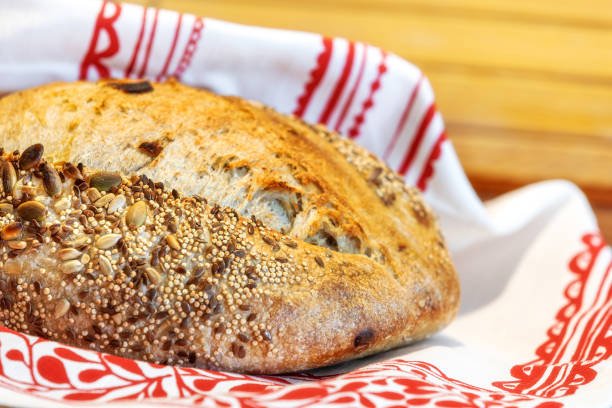Homemade freshly bread. Sourdough wheat rye loaf with seeds still-life with napkin