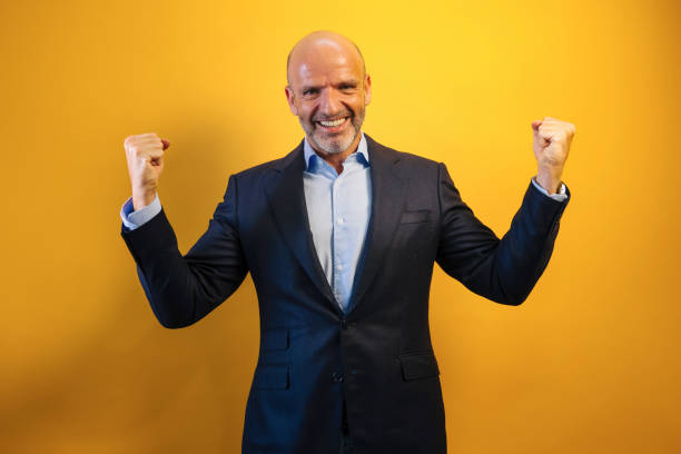 istock A man in a dark blue suit raises his arms in euphoria. 2171008255