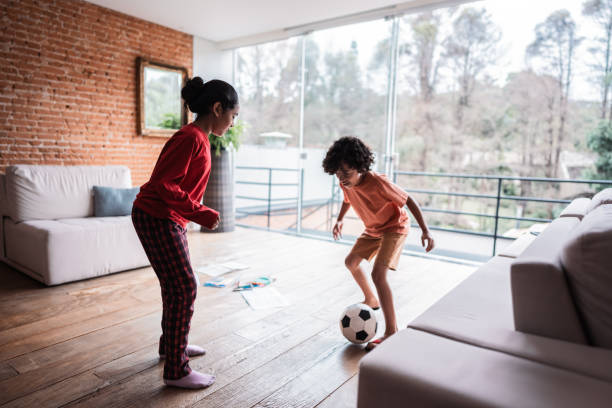 istock Siblings playing soccer at home 2171011734