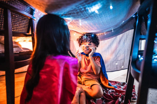 istock Siblings playing as heroes in a tent at home 2171012239