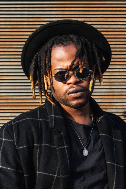 istock Stylish black man with dreadlocks on street 2171012259