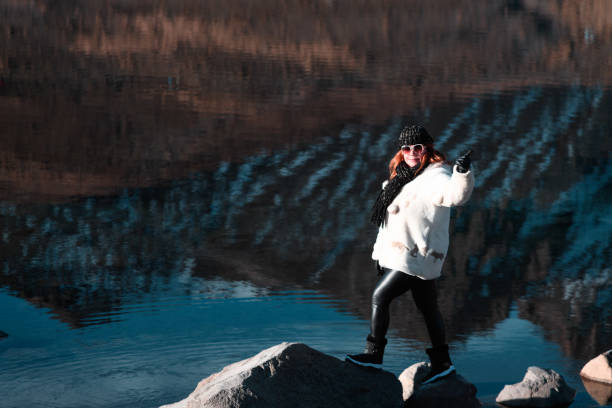 Tourist in the Nevado de Toluca Volcano next to reflection in the moon lagoon
