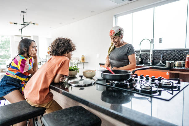 istock Mother with kids cooking at home 2171015695