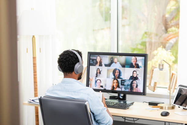 istock Young adult male attends a virtual event using his home office 2171016493