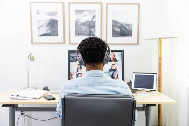 istock Rear view of unrecognizable male attending a video conference 2171016549