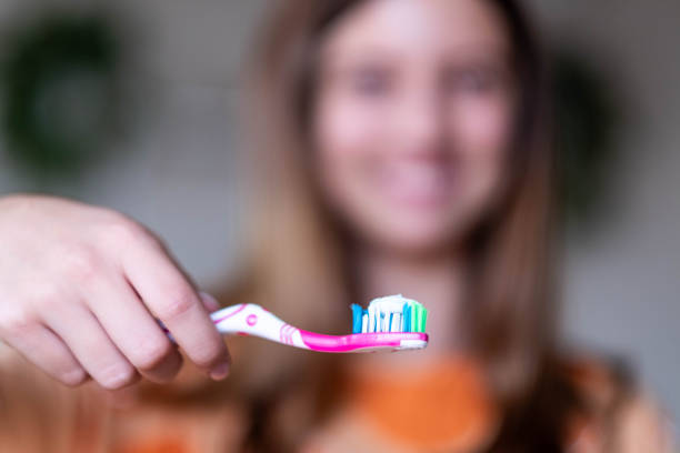 istock the girl brushes her teeth with a brush and toothpaste 2171018248