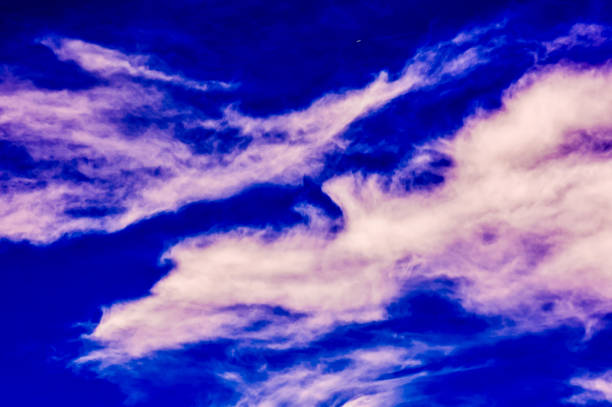 The sky is blue and cloudy. The clouds are white and fluffy