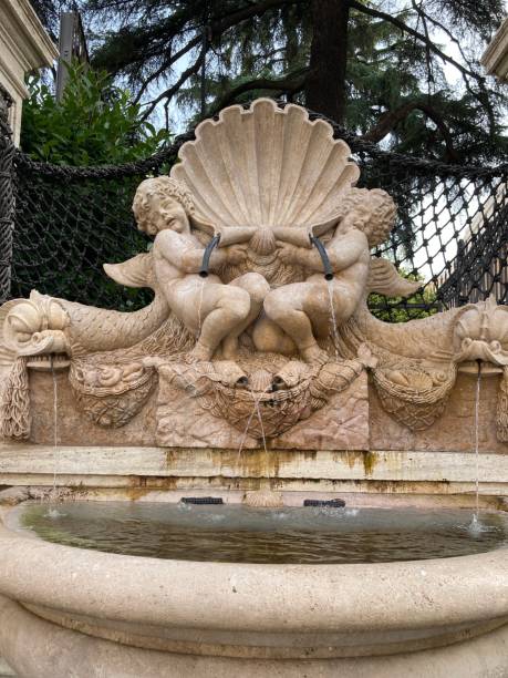 istock Stone fountain with two angels holding a shell. 2171024039