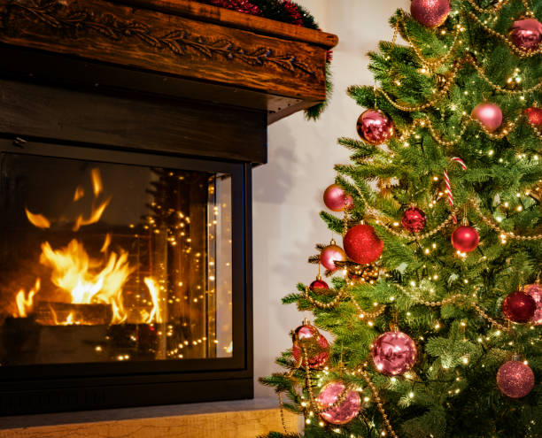 istock Decorated with Red Ornament Christmas Tree near the Fireplace 2171026592