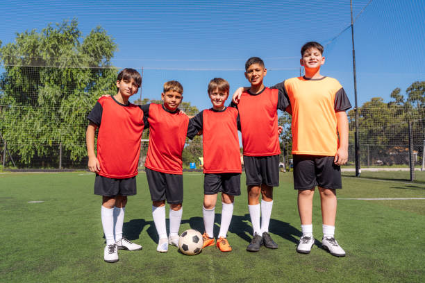 istock young boys in team uniforms stand together on the Field 2171026739