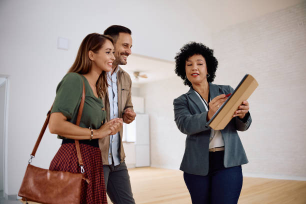 istock Happy couple going through housing plans with their real estate agent while looking for a new home. 2171027218