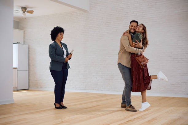 istock Young couple feeling excited while buying a new apartment. 2171027330