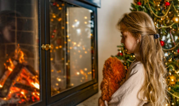 istock Young Blond Girl Looking at Fireplace 2171027750