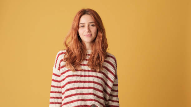 istock Smiling girl looking at camera on yellow background 2171029155
