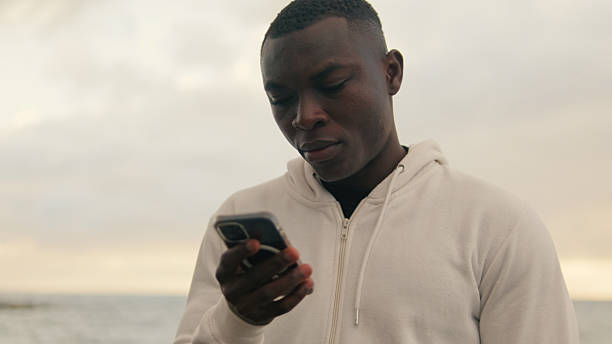 istock Close-up of young  man using a smartphone looking at the phone screen 2171030928