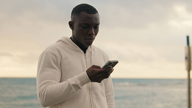 istock Close-up of young  man using a smartphone looking at the phone screen 2171030930