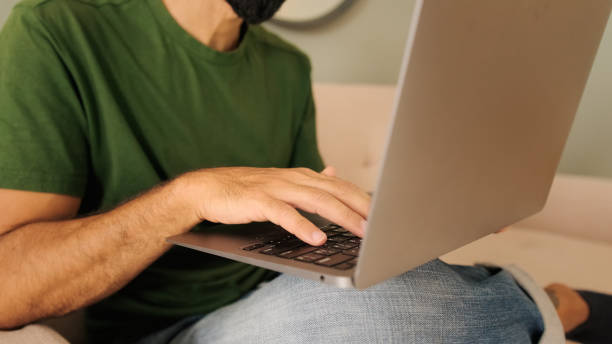 istock Close-up of a young man's hands working on a laptop 2171031110
