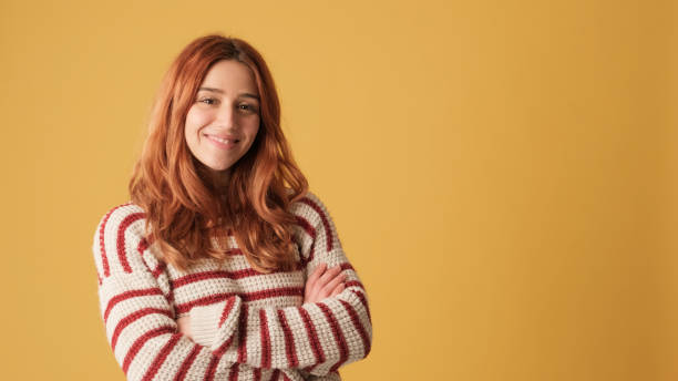 istock Girl looking at camera, space on yellow background in studio 2171032308
