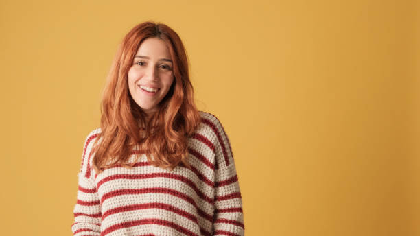 istock Girl looking at camera, space on yellow background in studio 2171032344