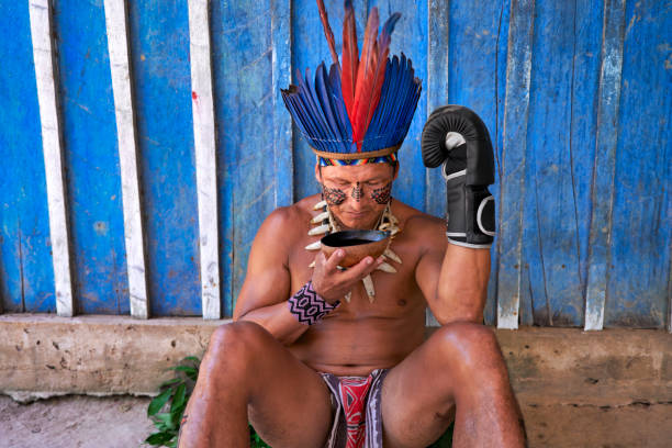 istock An indigenous man from the Brazilian Amazon rests and drinks water after training boxing kit 2171035854
