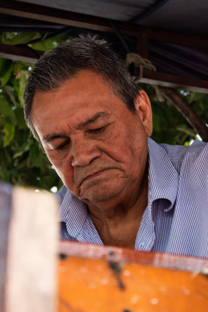 A look of an elderly Latino man as he produces Guarapo