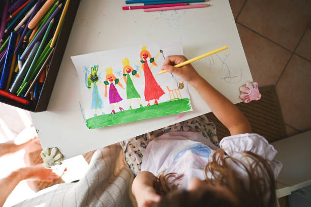unrecognizable girl draw family.