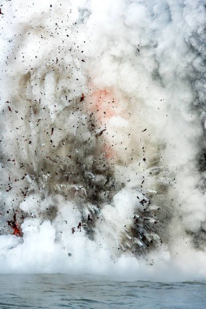 istock Lava tube flowing into ocean in Hawaii at dawn causes explosion 2171042698