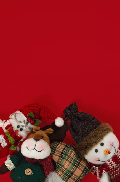 Christmas dolls on red background with copy space on red background.
