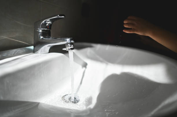 Running water in bathroom with sunlight.