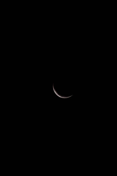 istock A small crescent moon is the only light in the dark sky 2171046242
