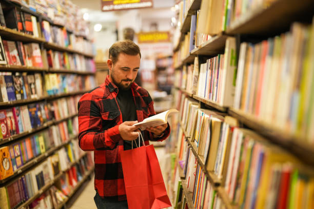 istock man looking at books in bookstore 2171046271