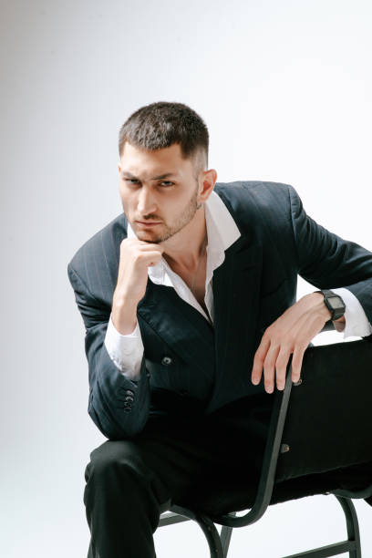 istock Handsome man, fashion model sits on chair 2171047566