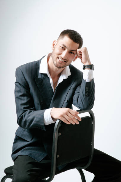 istock Handsome man, fashion model sits on chair 2171047579
