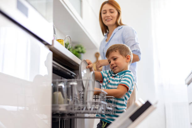 istock Mom and son loading dishwasher, family teamwork 2171050794