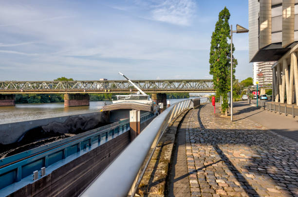 Frankfurt, Germany - July 29, 2024: A coal barge offloading along the shores in Frankfurt