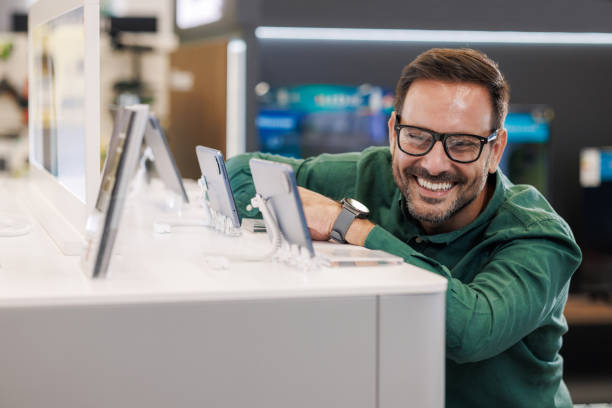 istock A man exploring new smart phone options at the electronics store 2171051922