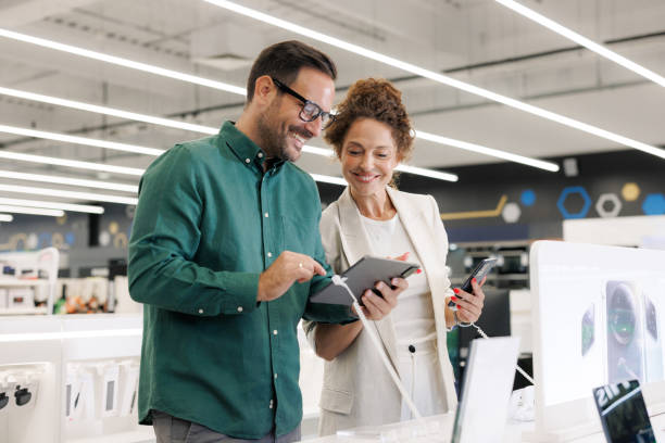 A couple enjoys shopping for smart devices and electronics in a modern store