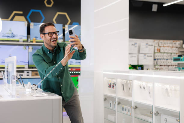 istock Happy shopper testing new smart phones in a tech store 2171051947