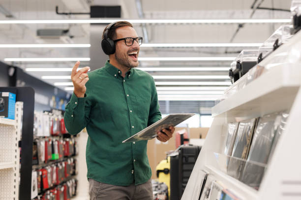 istock A man in his 30s expressing pleasure and amusement while shopping long play records 2171052026
