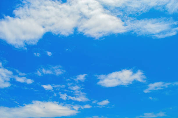 Serene blue sky with fluffy white clouds, ideal for backgrounds or nature themes, capturing the essence of a peaceful day.