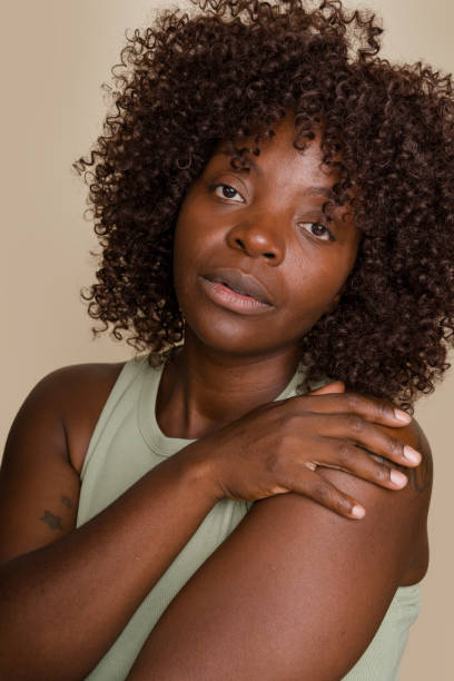istock woman is posing and holding her shoulder 2171054274