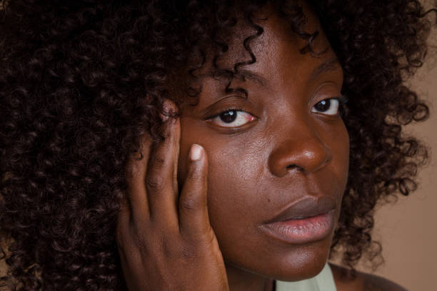 istock woman touching her face and looking concerned 2171054610